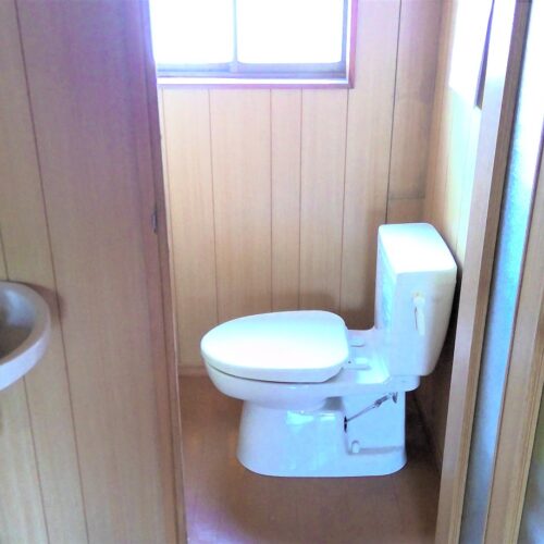 鹿児島県肝付町の物件の1階のトイレは簡易水洗の洋式トイレです。窓があり換気もできます。トイレの前には手洗いも設けられています。1階トイレは、来客も使用することになるので、離れにあるトイレと使い分けてもよいかもしれません。